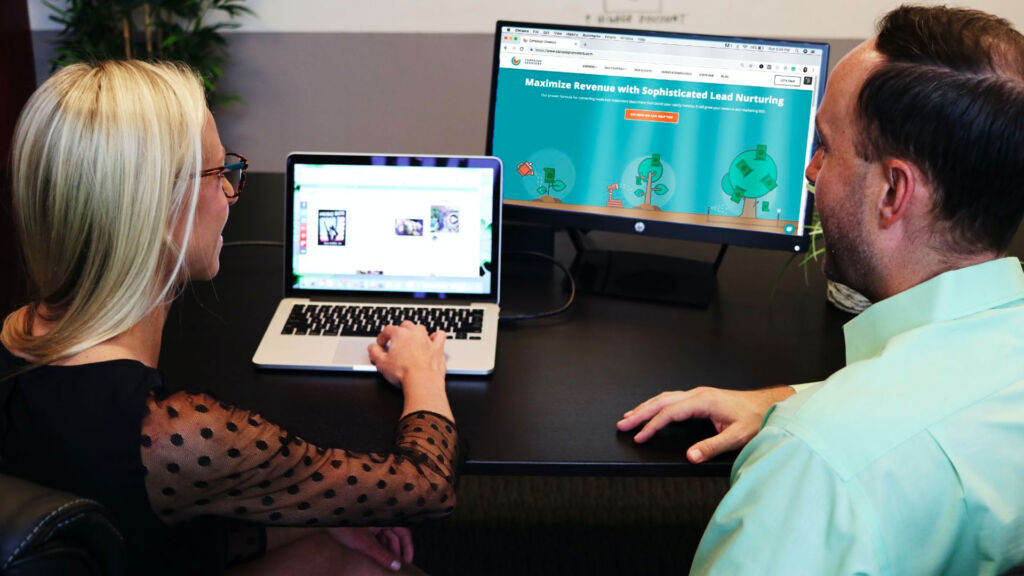 two teachers planning online learning on computers