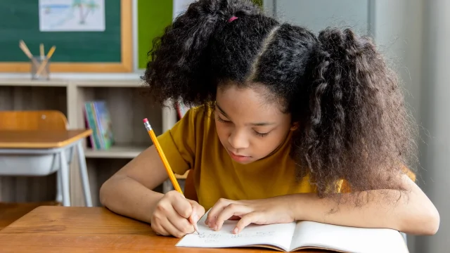 little girl journaling