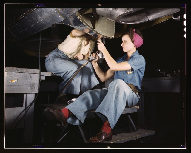 Women working under plane