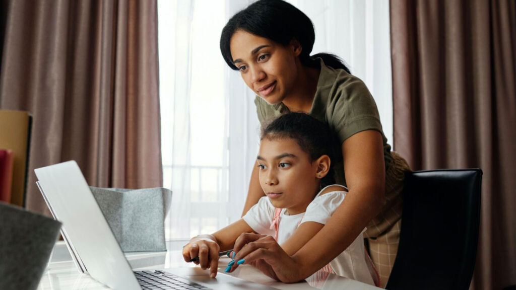 mom and her daughter working on a laptop