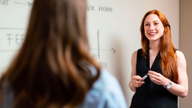 smiling teacher at a whiteboard