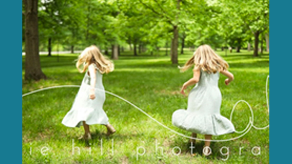 Two young girls running in a field