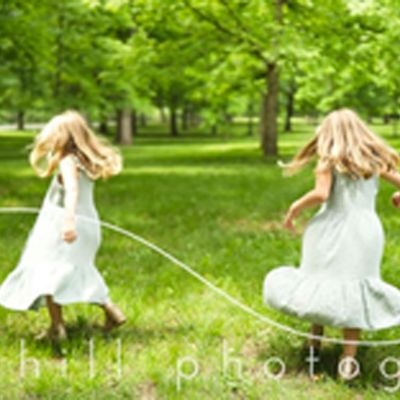 Two young girls running in a field
