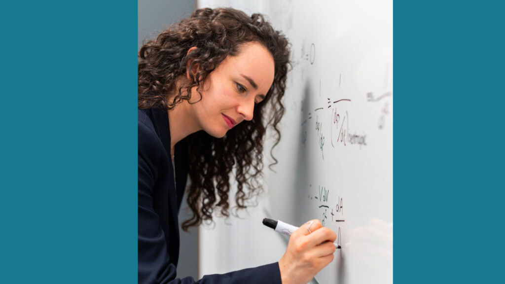 math teacher writing on whiteboard