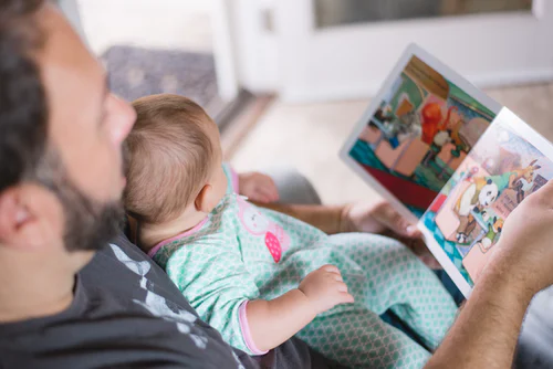 man reading to a baby