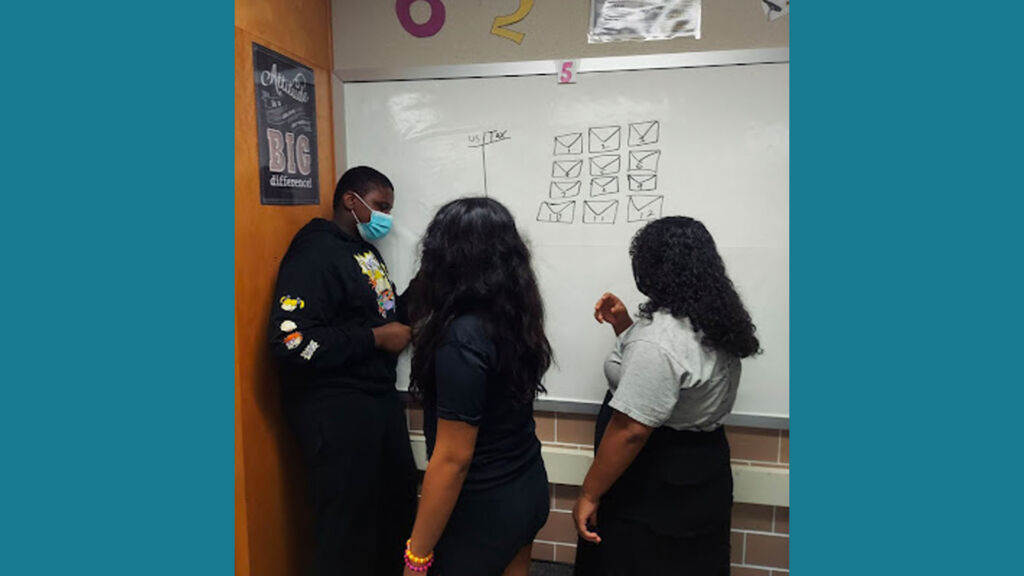 student's working at a whiteboard