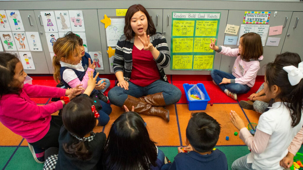 group of students sitting around their teacher