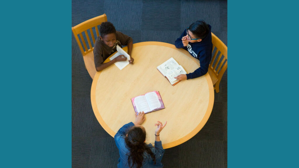 students reading at a table together