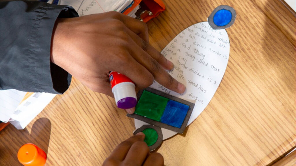 student hands working on a project