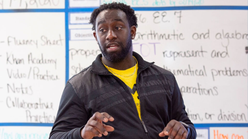 male teacher in front of a whiteboard