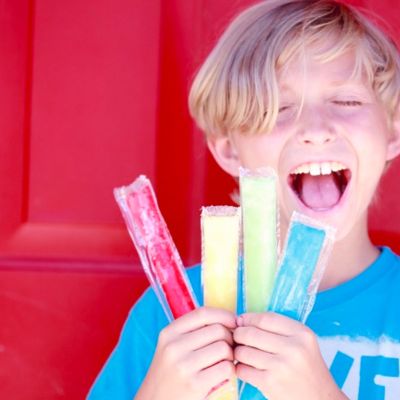young boy holding freeze pops