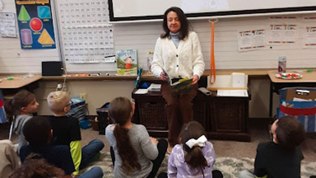 teacher and students doing a breathing practice