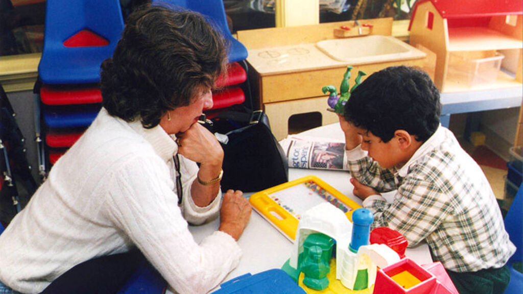 teacher working with a students sketching