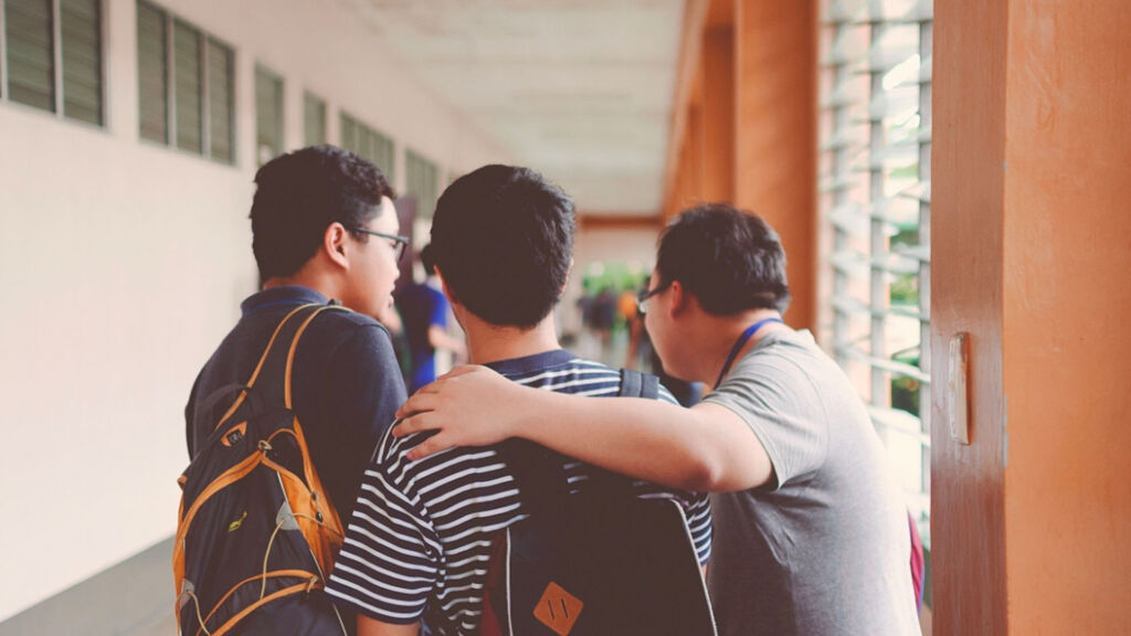 students speaking in the hallway