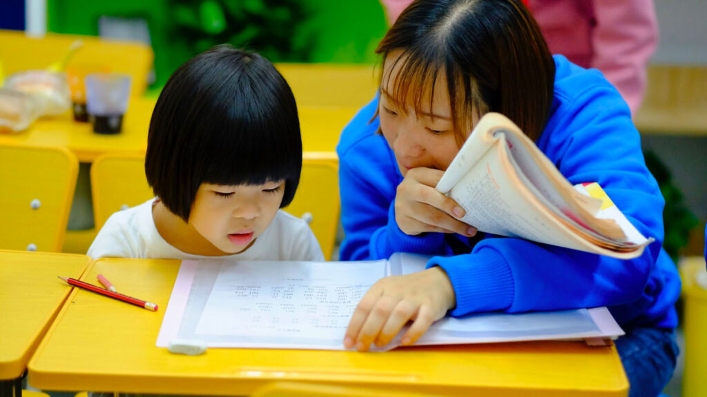 Teacher teaching a student.