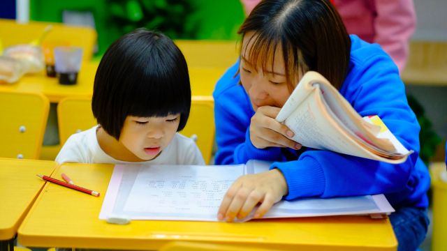 Teacher teaching a student.