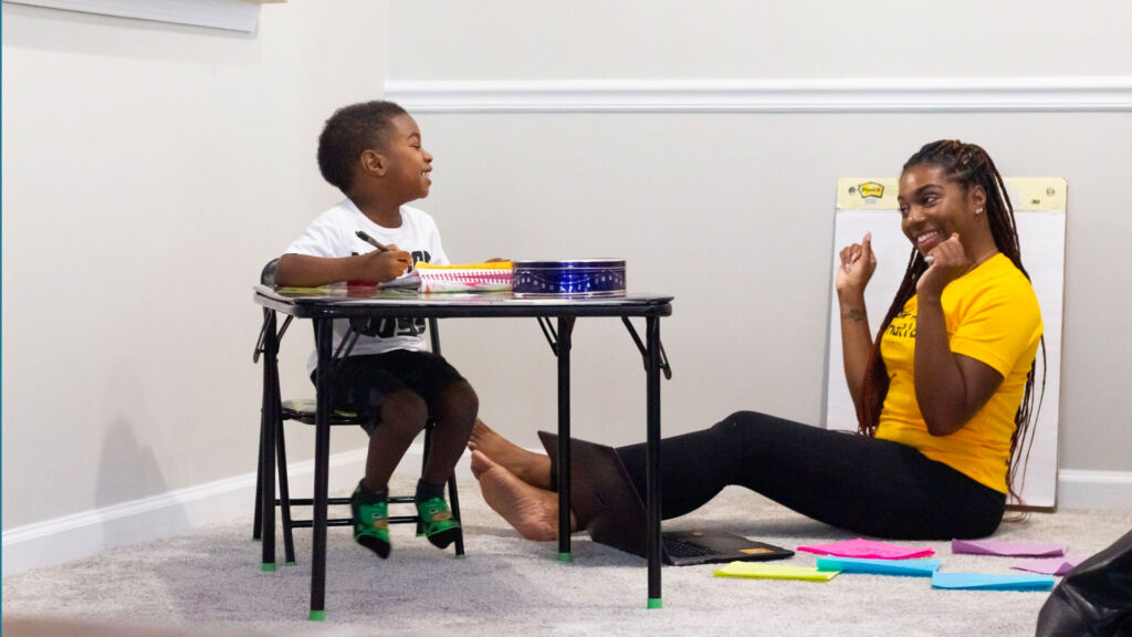 Woman teaching a child.