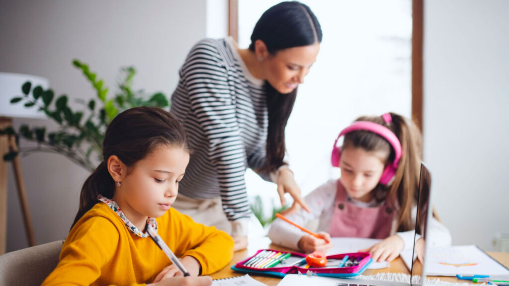 Children doing homework with an adult.