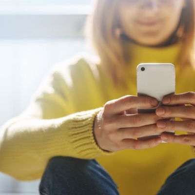 Educator using social media on a smart phone.