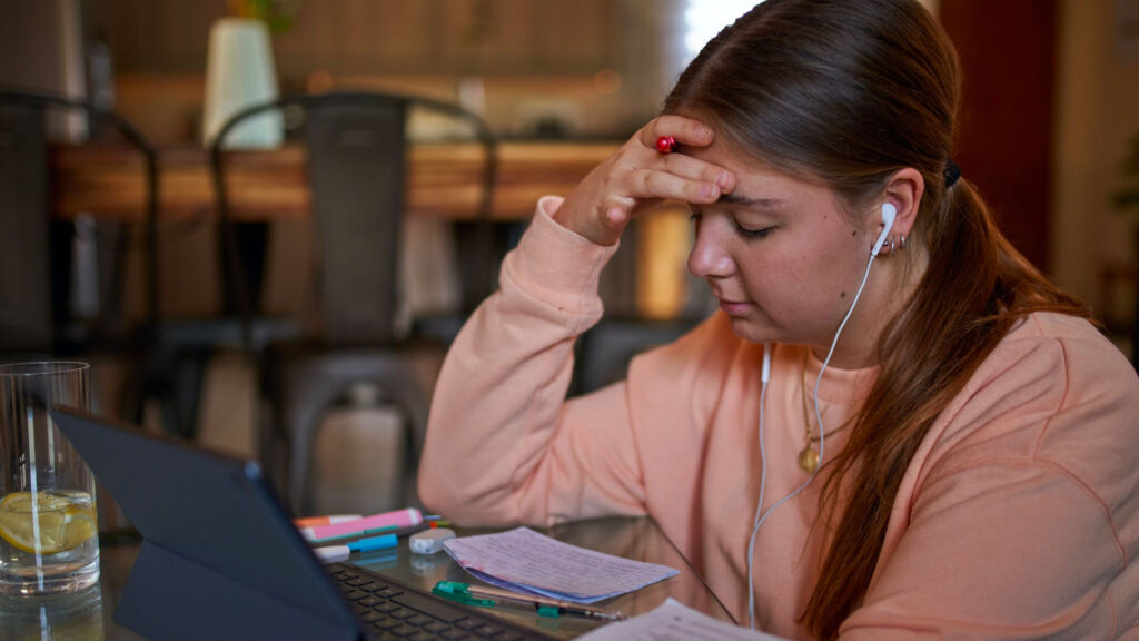 Student listening to music while working.