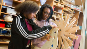 Students working on an engineering project made of wood.