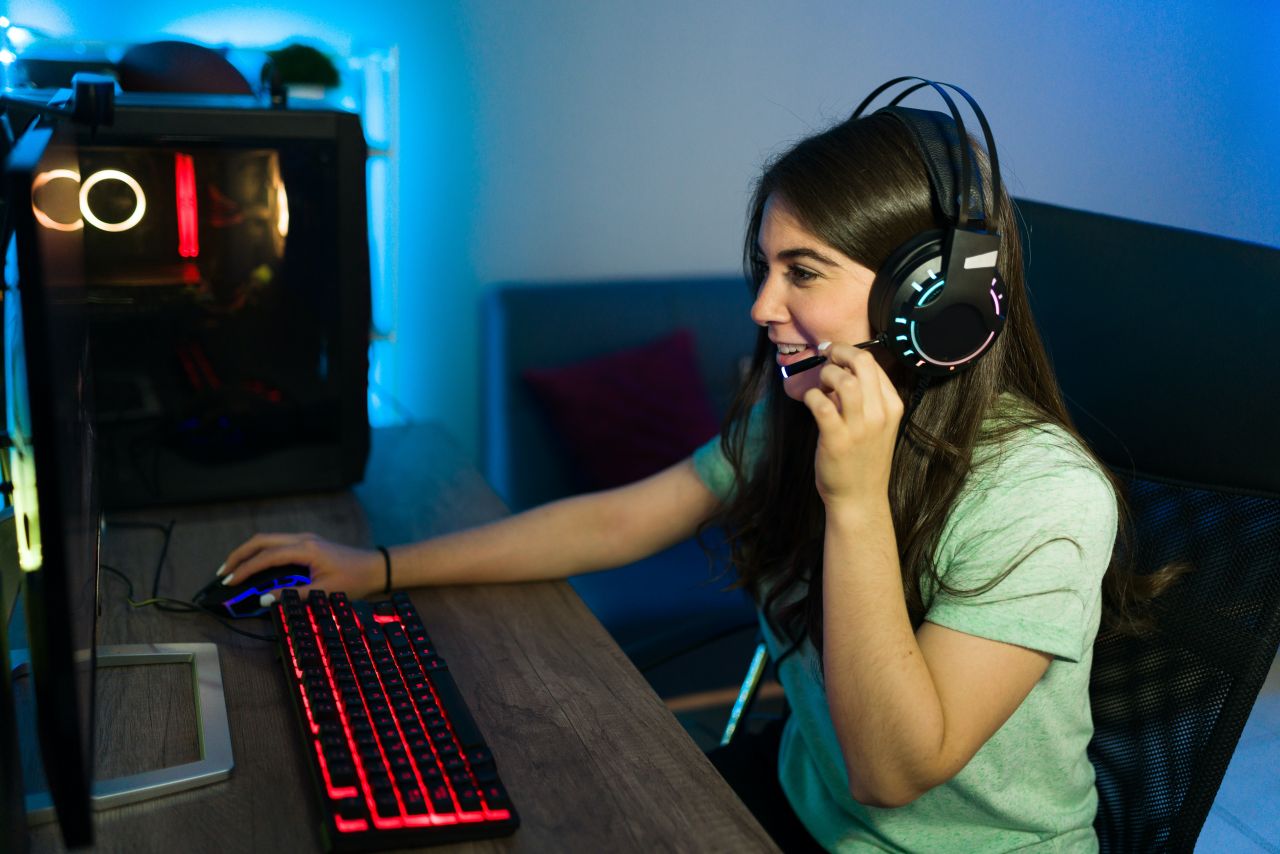 Person at a computer with a headset on.