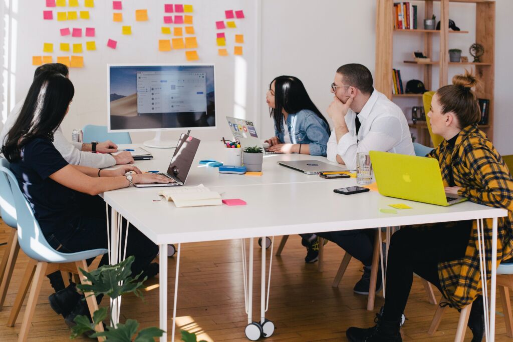 People sitting at a table, setting up a calendar.