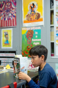 Elementary student interested in a book.