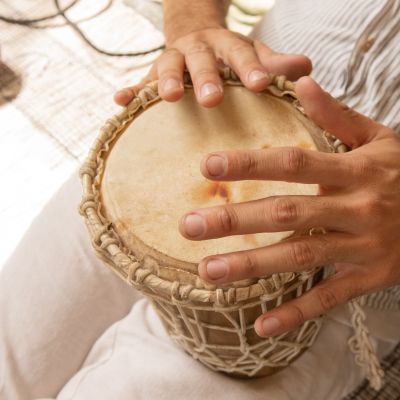 A person playing a small drum.