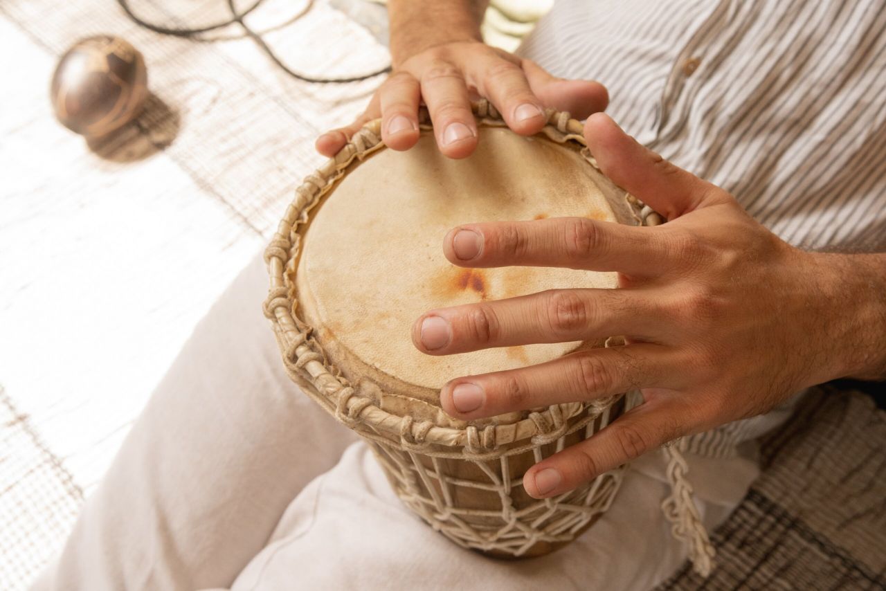 A person playing a small drum.