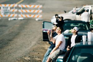 People sitting and looking at an eclipse, with eye protection.