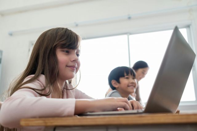 Children is a classroom using technology.