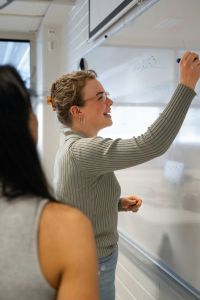 Student using a white board.