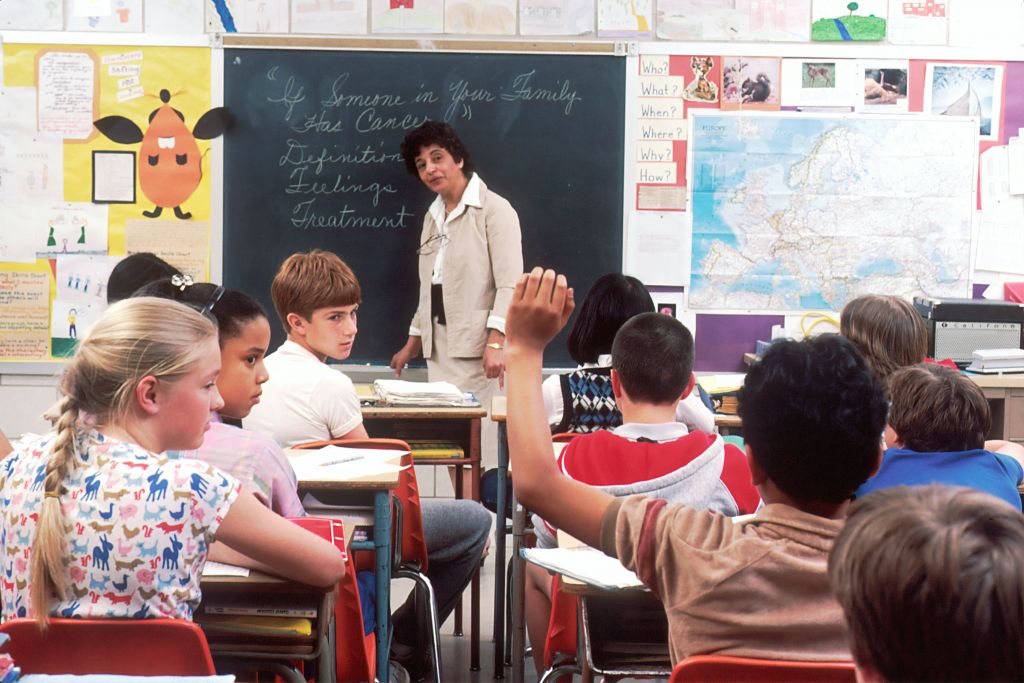 Students in a classroom with a teacher.