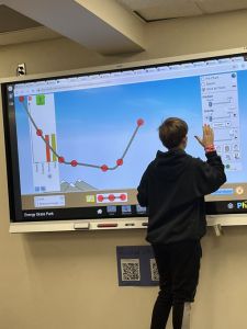 Student using an interactive whiteboard.