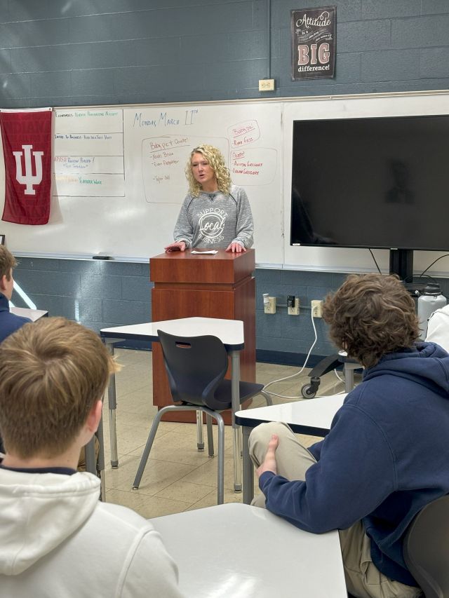 Person giving a presentation at a podium.