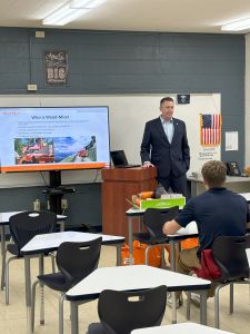 Person giving a presentation next to a podium.