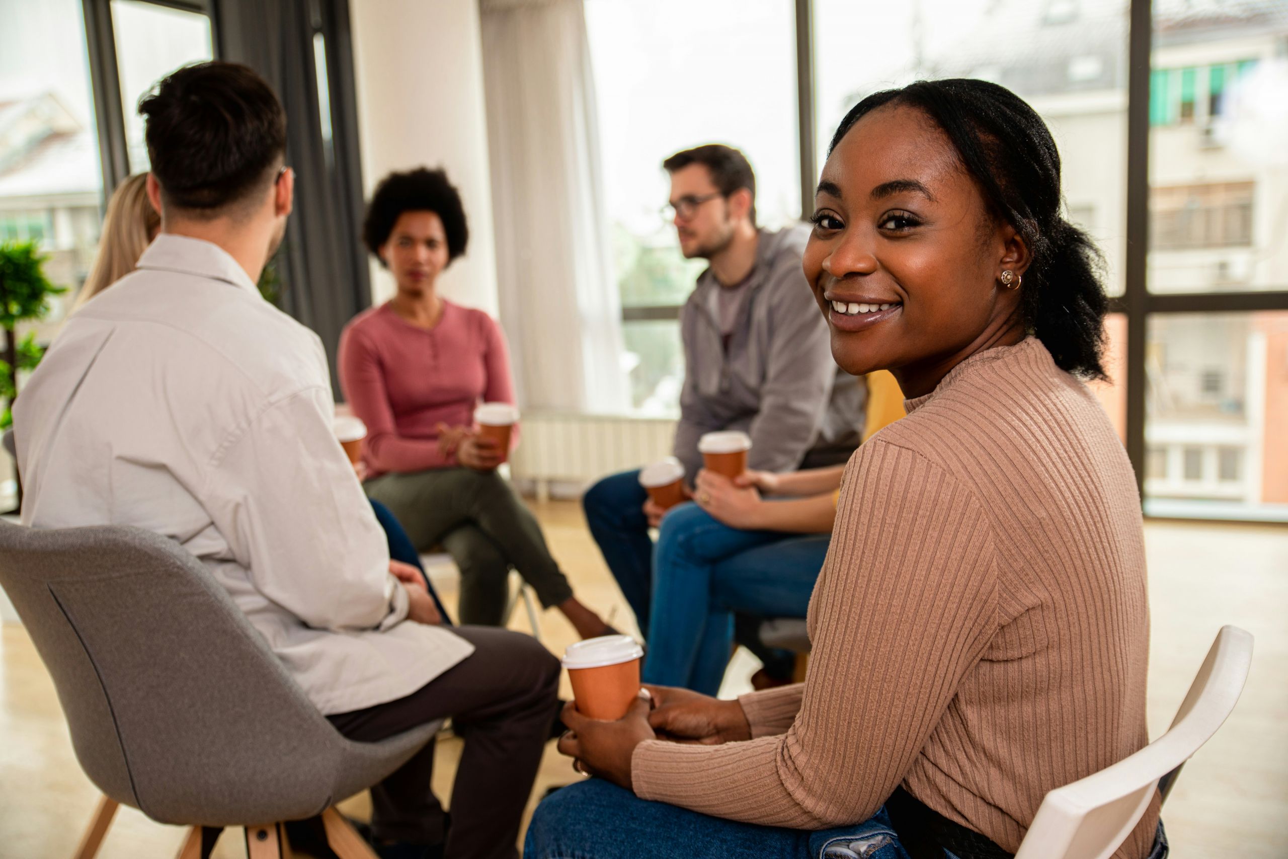 People sitting in chairs in a circle.