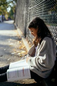 Girl sitting outside and studying.