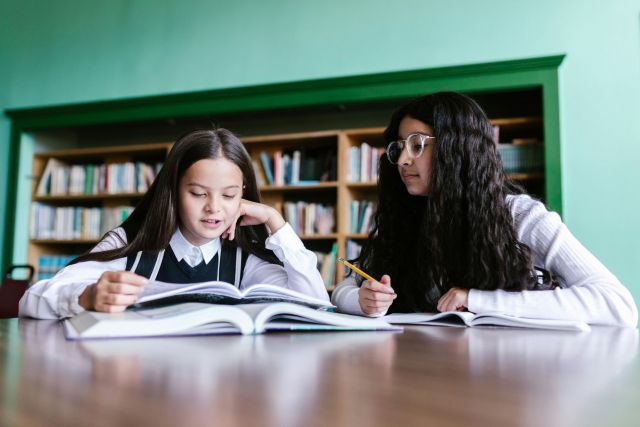 Two girls studying in the library.