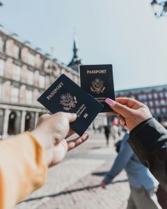 Two people holding up passports.