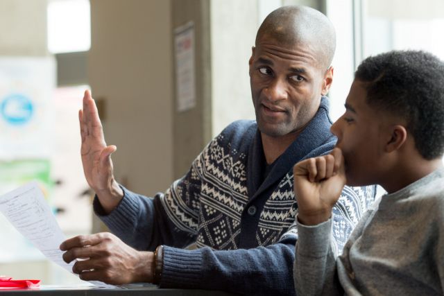 Teacher helping a student.