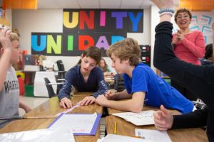 Eighth-graders work together on a story project in Spanish class.