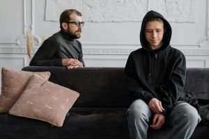 A teacher sitting with a student.