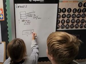 Two students working a problem out together.