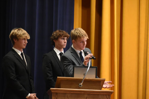 Three Students at a podium