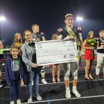 Homecoming King with check.