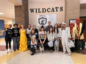 Students in costumes, posing for a picture.