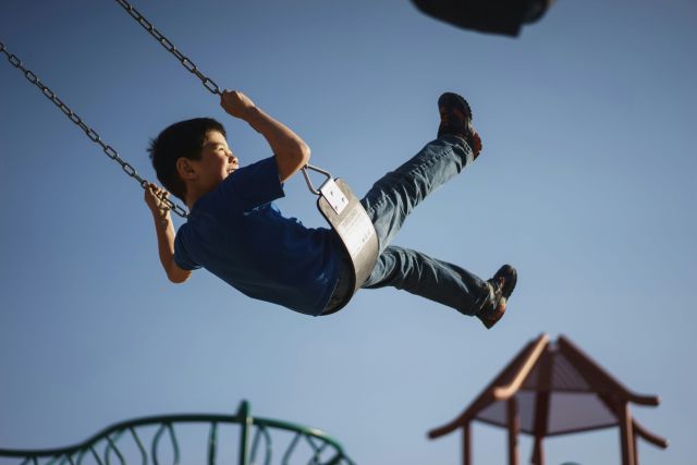 Child swinging on a swing.