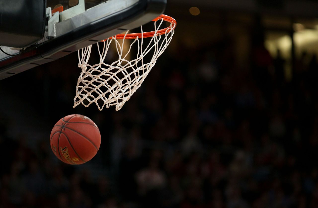 Basketball under the hoop.